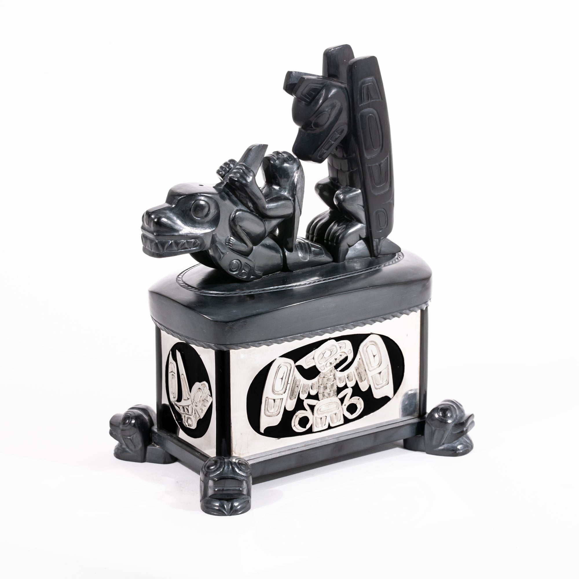 Haida argillite killer whale and thunderbird argillite and sterling silver box done by master Haida artist Ding Hutchingson on a white background showing the right and front side