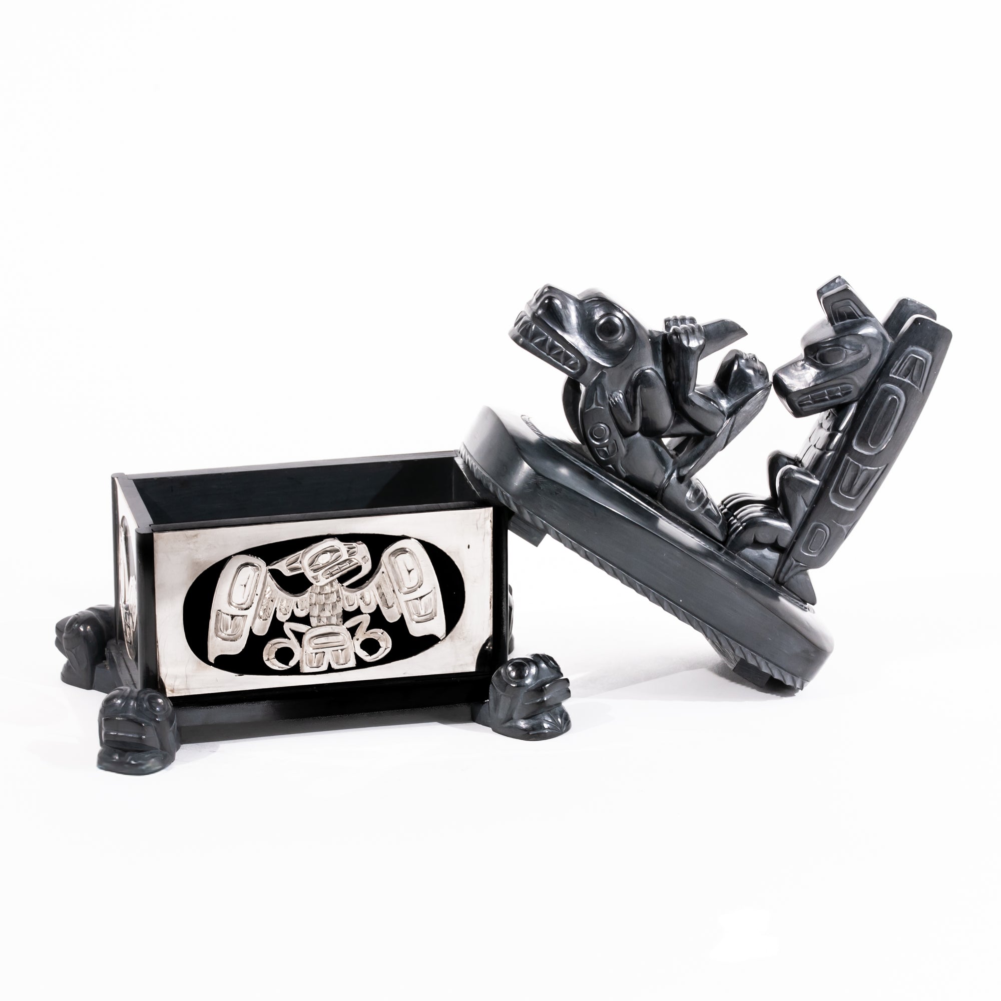 Haida argillite killer whale and thunderbird argillite and sterling silver box done by master Haida artist Ding Hutchingson on a white background showing the open lid