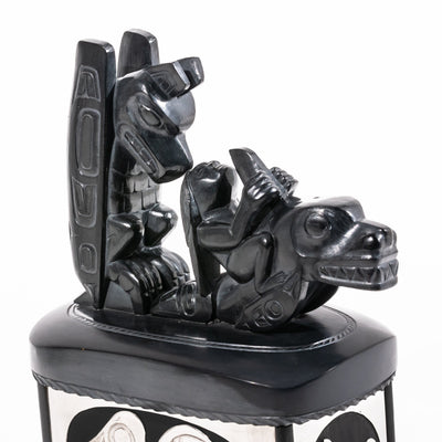 Haida argillite killer whale and thunderbird argillite and sterling silver box done by master Haida artist Ding Hutchingson on a white background showing close up of the top