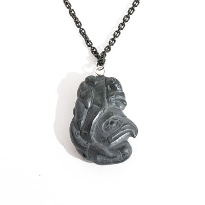 Black Argillite Octopus pendant necklace with intricate Haida Carvings on a white background made by Local Haida Gwaii Artist Melanie Russ