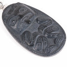 Close up of  Black Argillite Bear pendant necklace with intricate Haida Carvings showcasing the 3-d depth of the carving on a white background made by Local Haida Gwaii Artist Melanie Russ