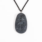 Front of Black Argillite Bear pendant necklace with intricate Haida Carvings showcasing the 3-d depth of the carving on a white background made by Local Haida Gwaii Artist Melanie Russ