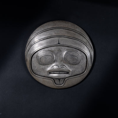 Fungus man mask casting with intricate carvings by Cori Savard on a dark black background