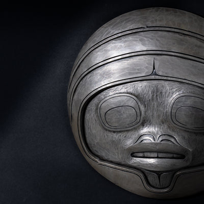 Close up of Fungus man mask casting with intricate carvings by Cori Savard on a dark  background