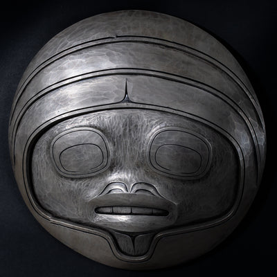 Fungus man mask casting with intricate carvings by Cori Savard on a dark wooden background