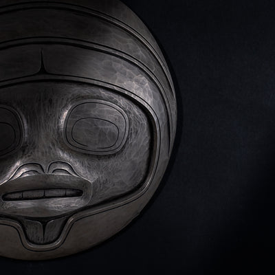Close up of Fungus man mask casting with intricate carvings by Cori Savard on a dark black background