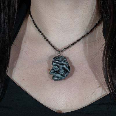 Close up second side of Black Argillite Octopus pendant necklace with intricate Haida Carvings on a white background made by Local Haida Gwaii Artist Melanie Russ