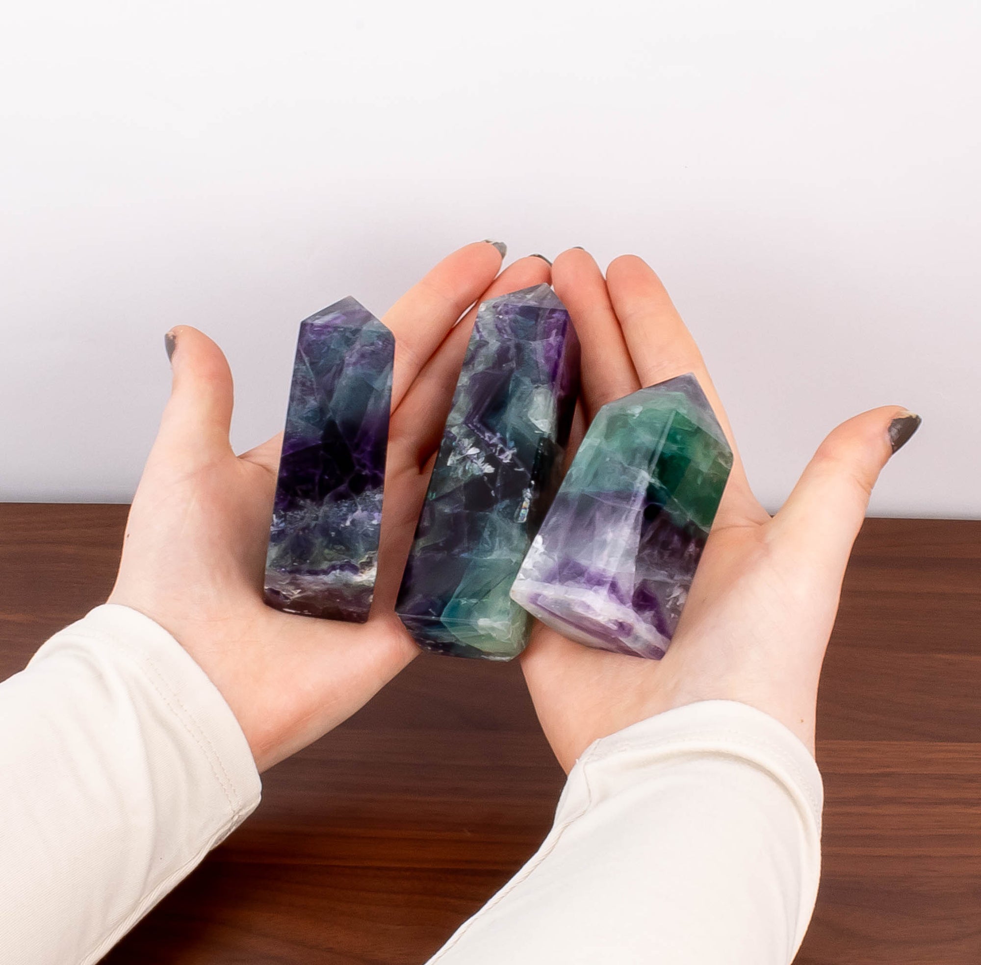 Hands holding fluorite crystals.
