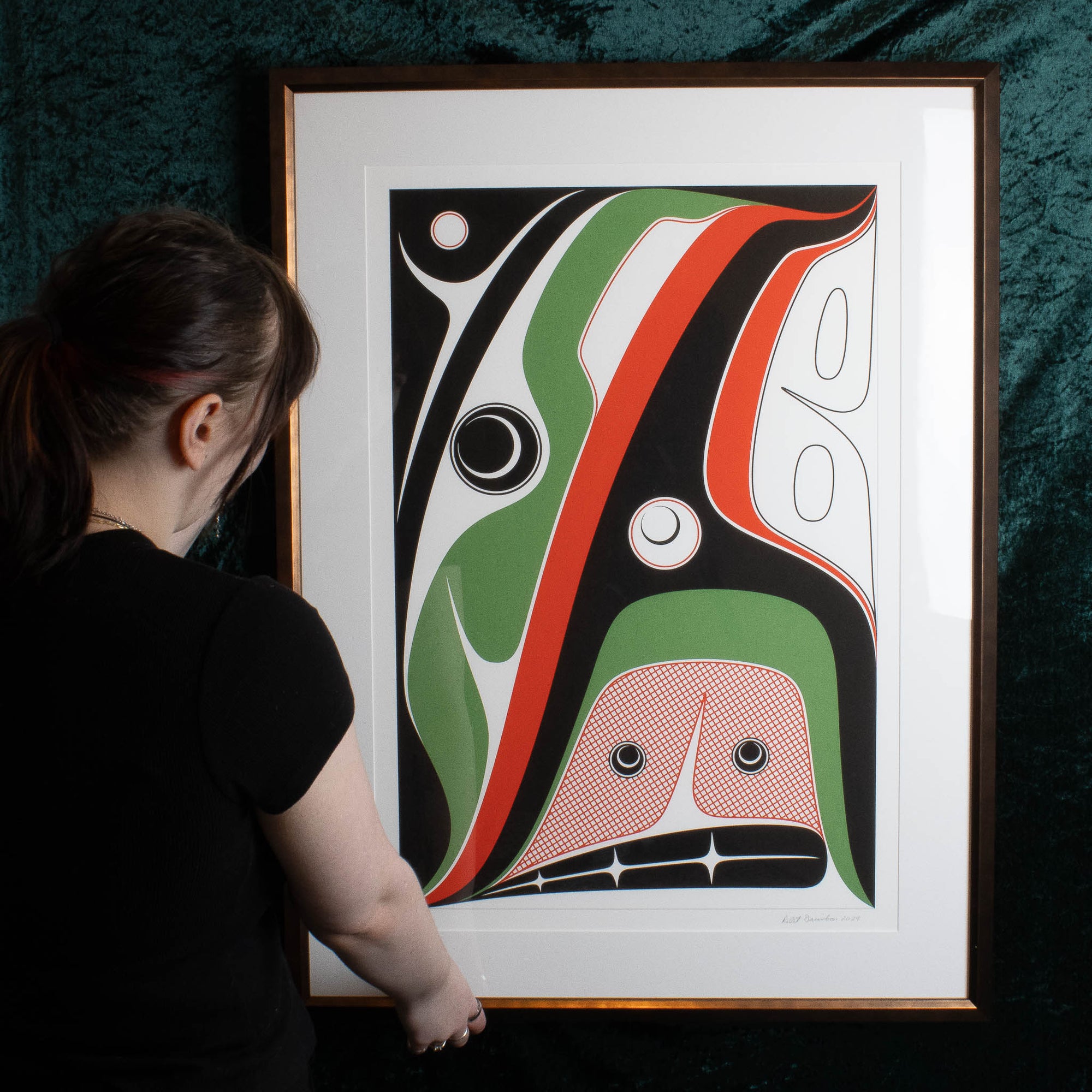 Framed Hope Print by Robert Davidson held by a model with a green background