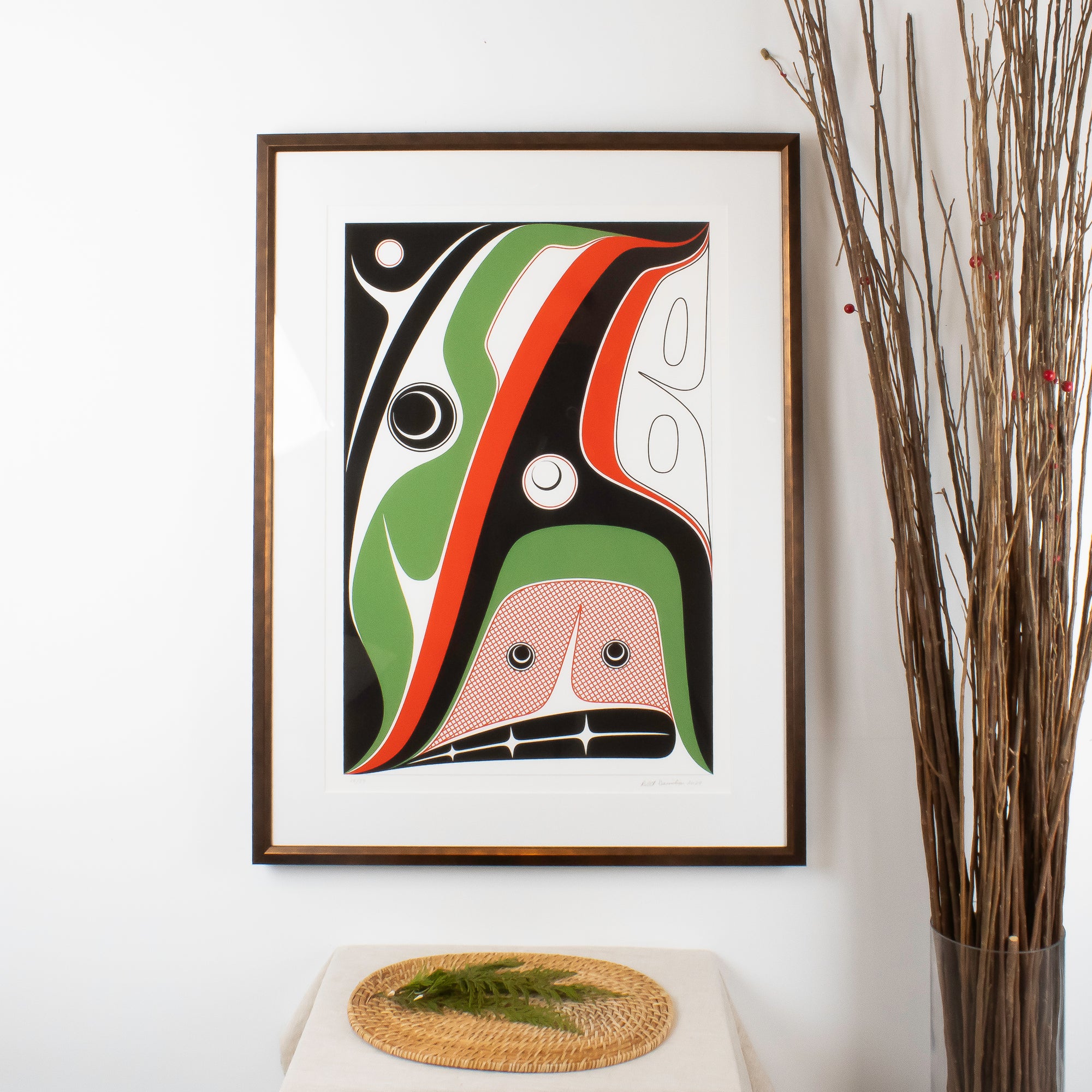 Hope Art Print by Haida Artist Robert Davidson, Framed in a brass style, in an interior design.