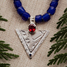 Sterling-Silver-Hummingbird-Pendant-with-Blue-Beads-Close-up-Linen-Backdrop