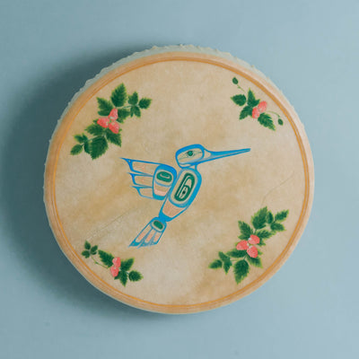 'Tea Time' Hummingbird Haida Drum by Danielle Louise Allard on a light blue background.