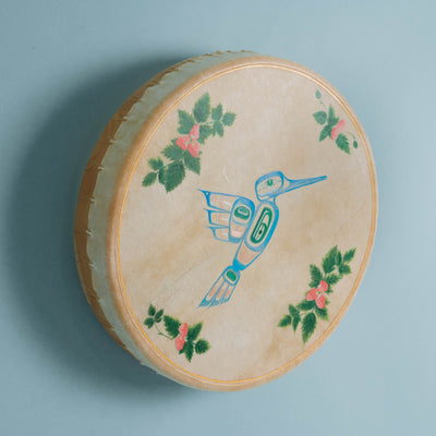 Round drum with bird and floral design on a blue background