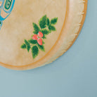 Close-up of a drum corner with floral design on a light blue background