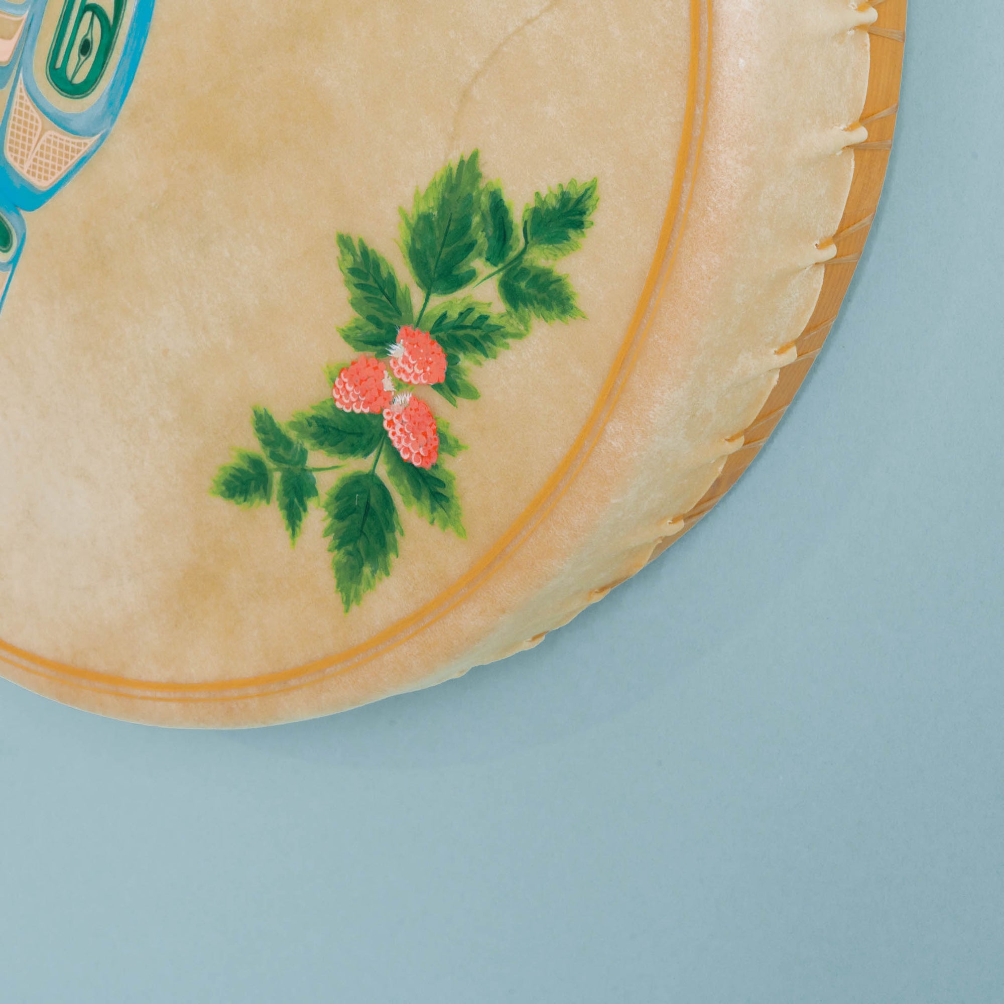 Close-up of a drum corner with floral design on a light blue background