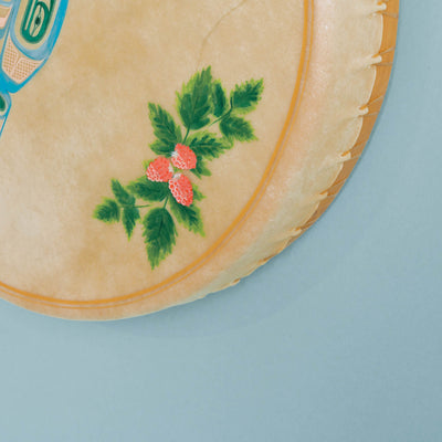 Close-up of a drum corner with floral design on a light blue background