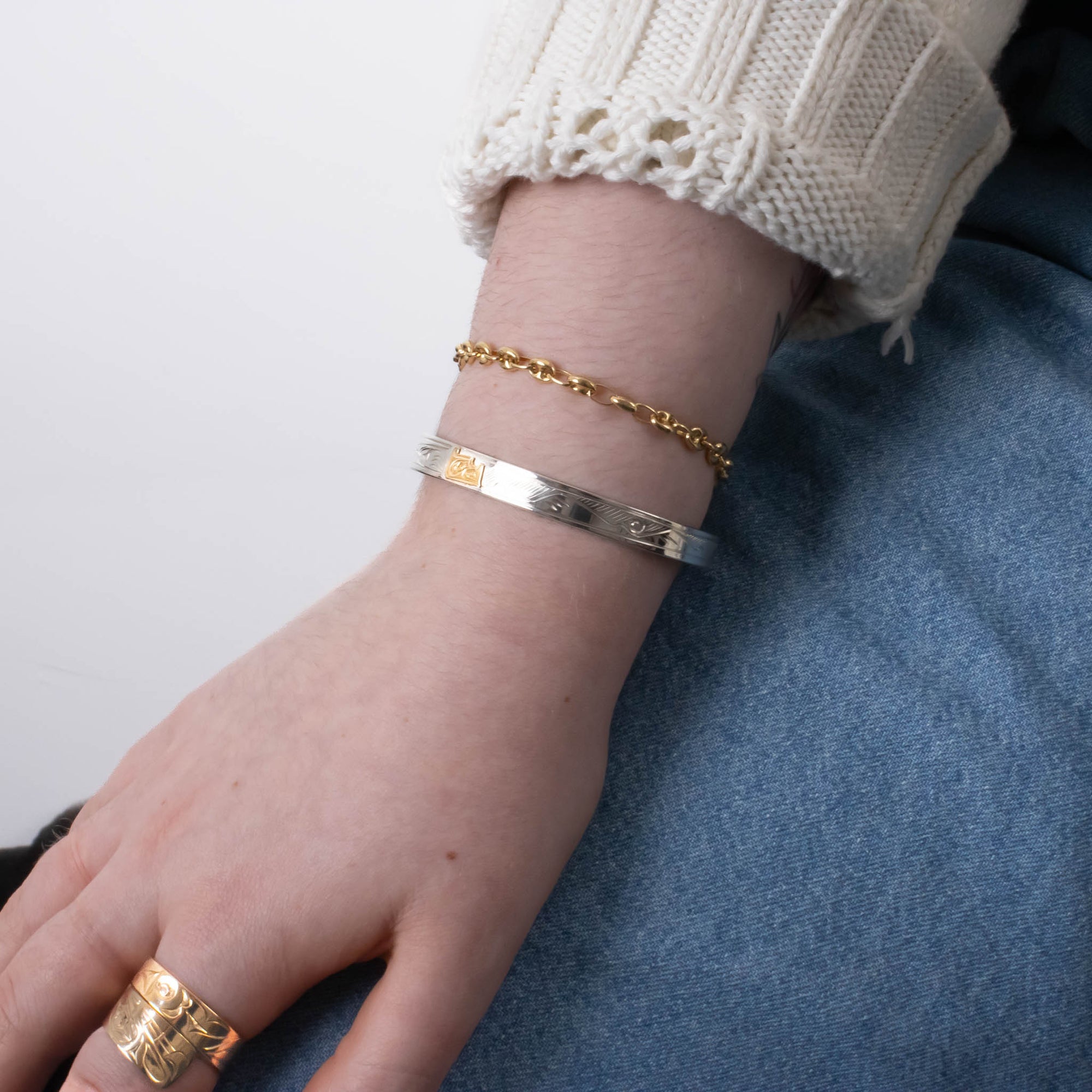Sterling silver and gold nature inspired wolf bracelet by agnes seaweed wisden worn by model