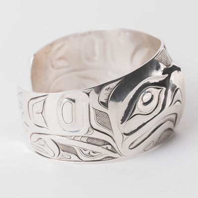 Side View Sterling Silver cuff bracelet with intricate Eagle and Salmon Repoussé desig