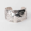 Sterling Silver cuff bracelet with intricate Eagle and Salmon Repoussé design on a white background