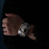 Hand wearing a silver