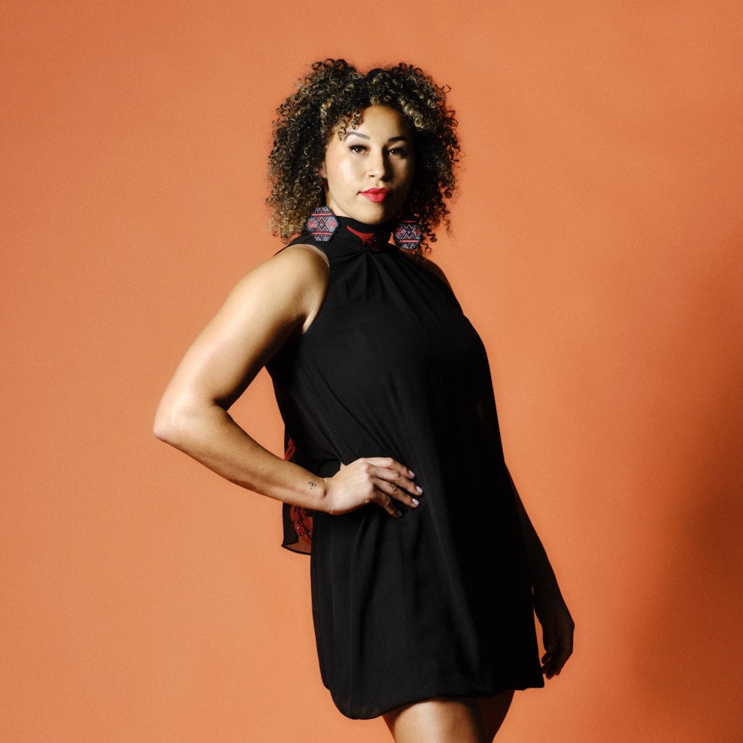 Beaded black and red earrings worn by model