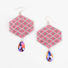 Pink beaded earrings with colorful teardrop pink charms on a white background