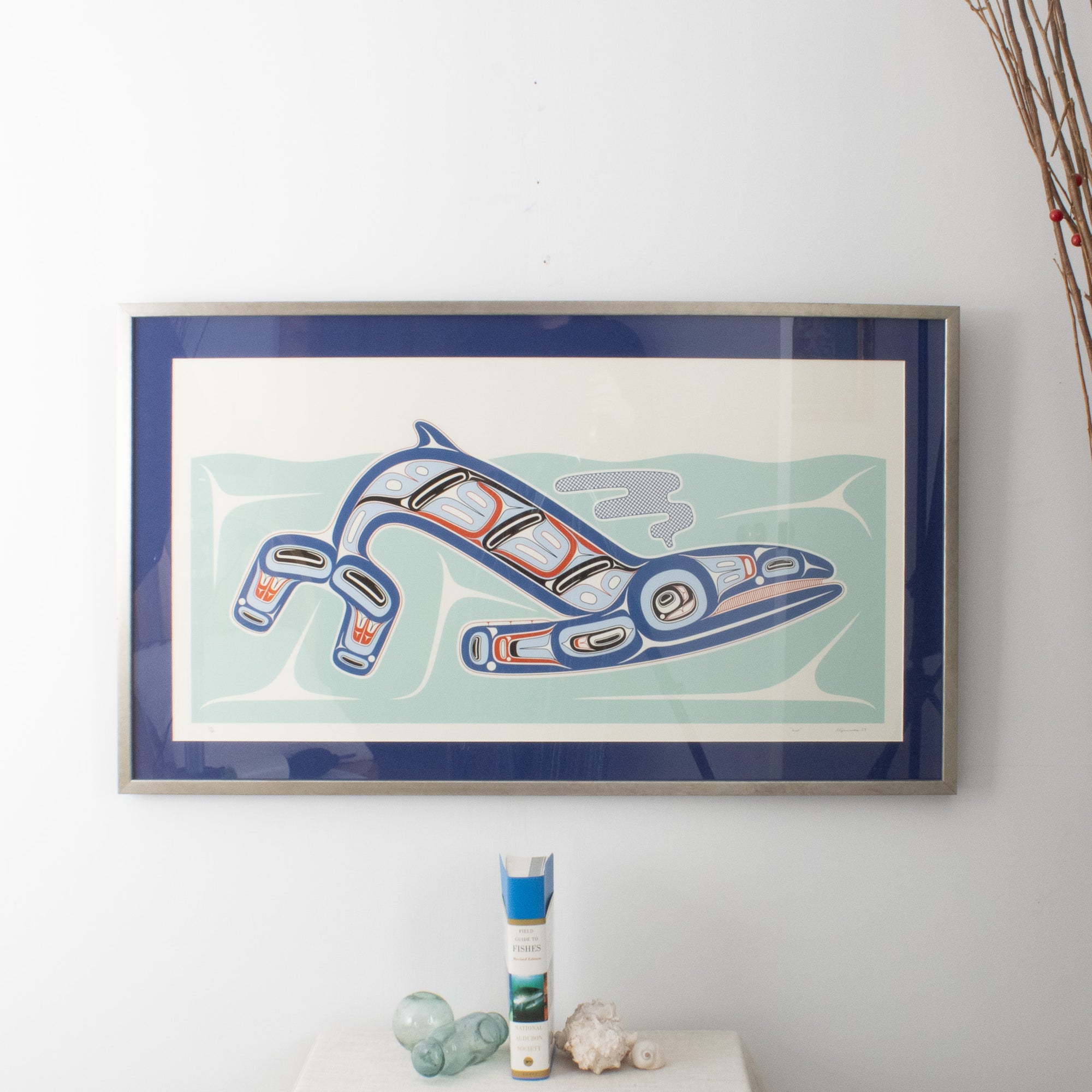 Framed whale art in a room