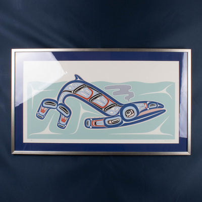 Blue Haida formline whale framed artwork on a blue background