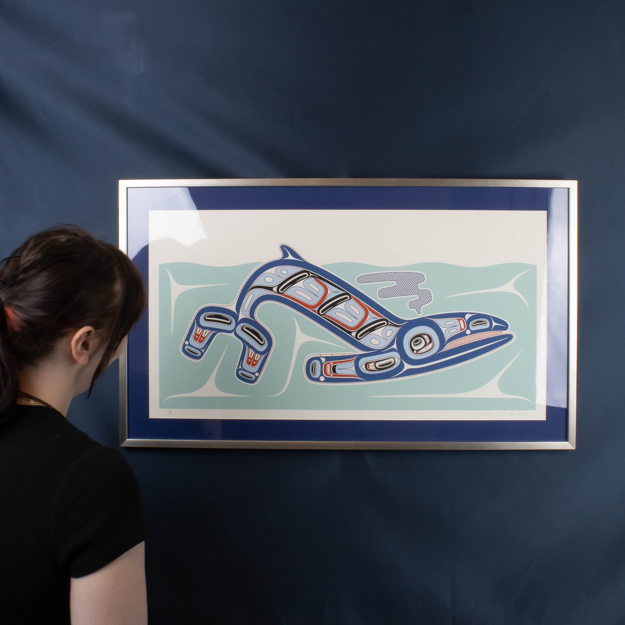 Model with framed Haida Formline whale artwork 