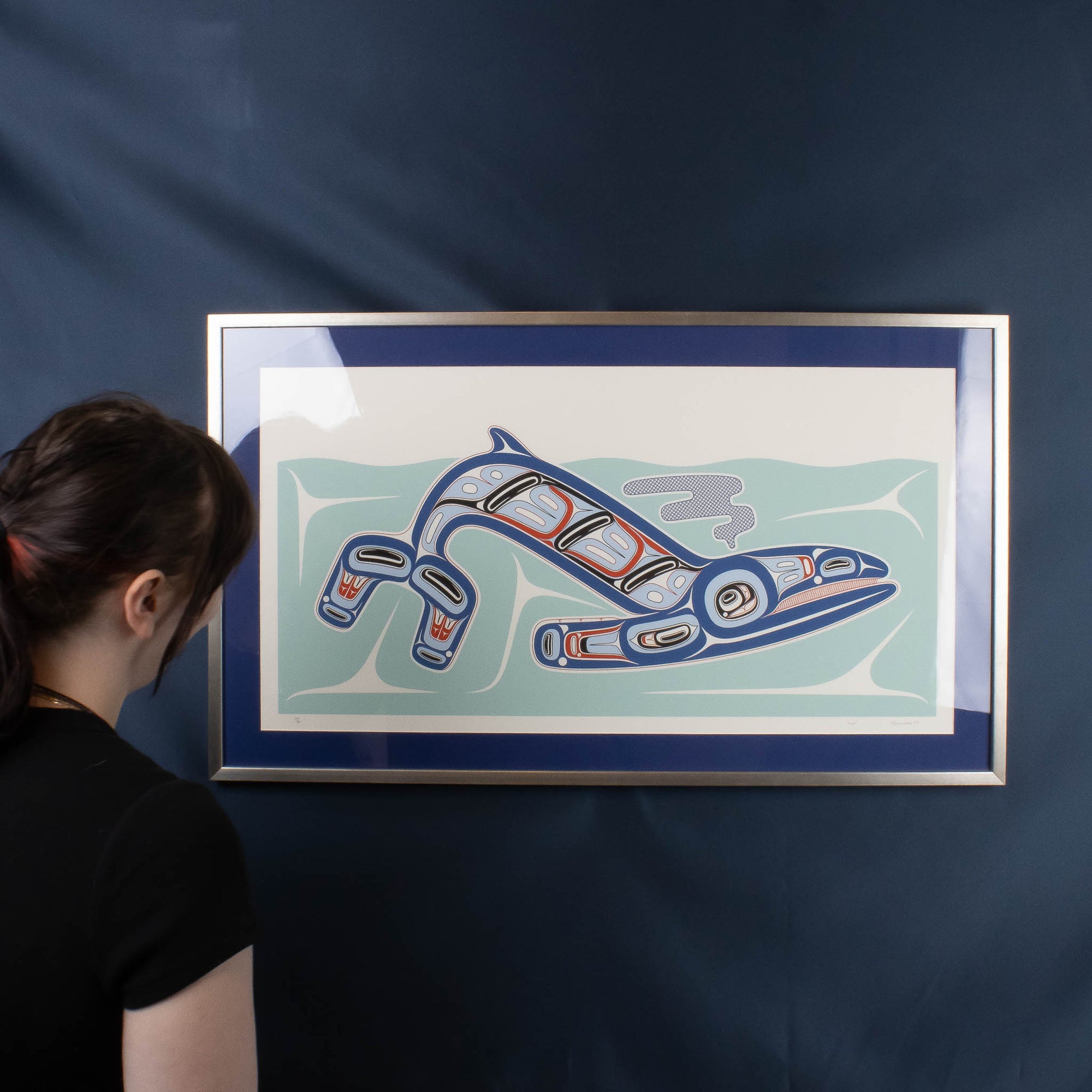 Model with framed Haida Formline whale artwork