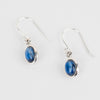 Pair of silver earrings with blue Kyanite stones on a white background