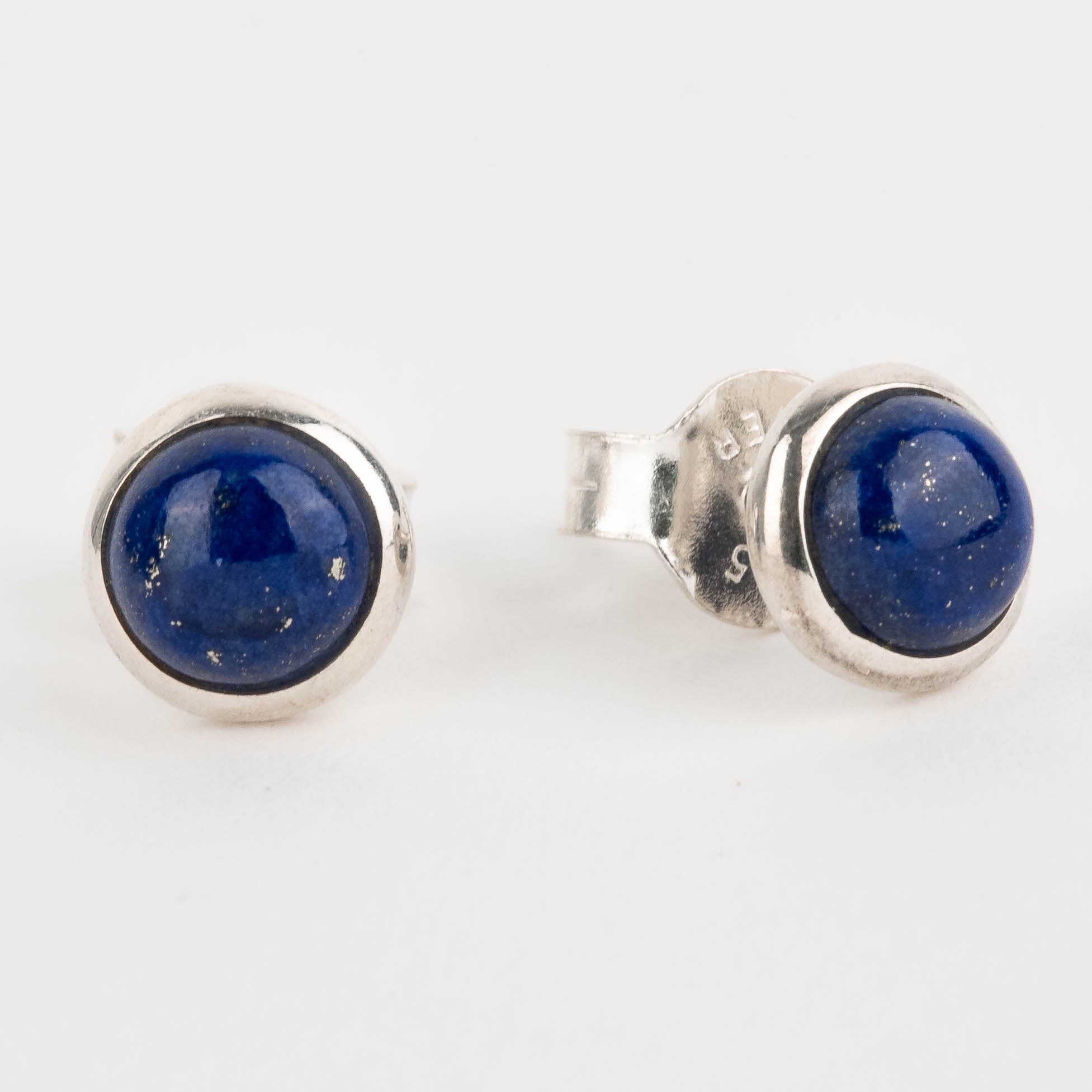 Pair of silver stud earrings with blue gemstones on a white background