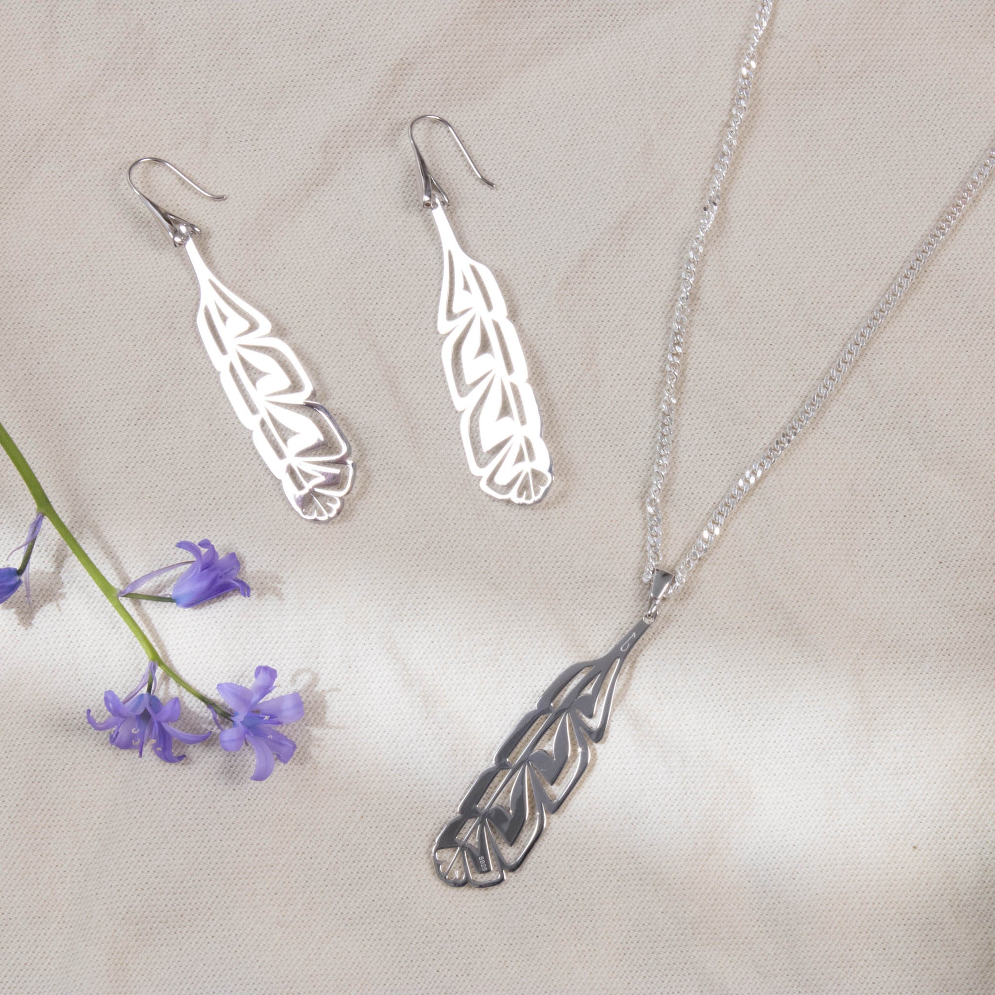 Sterling silver earrings and pendants with a purple flower