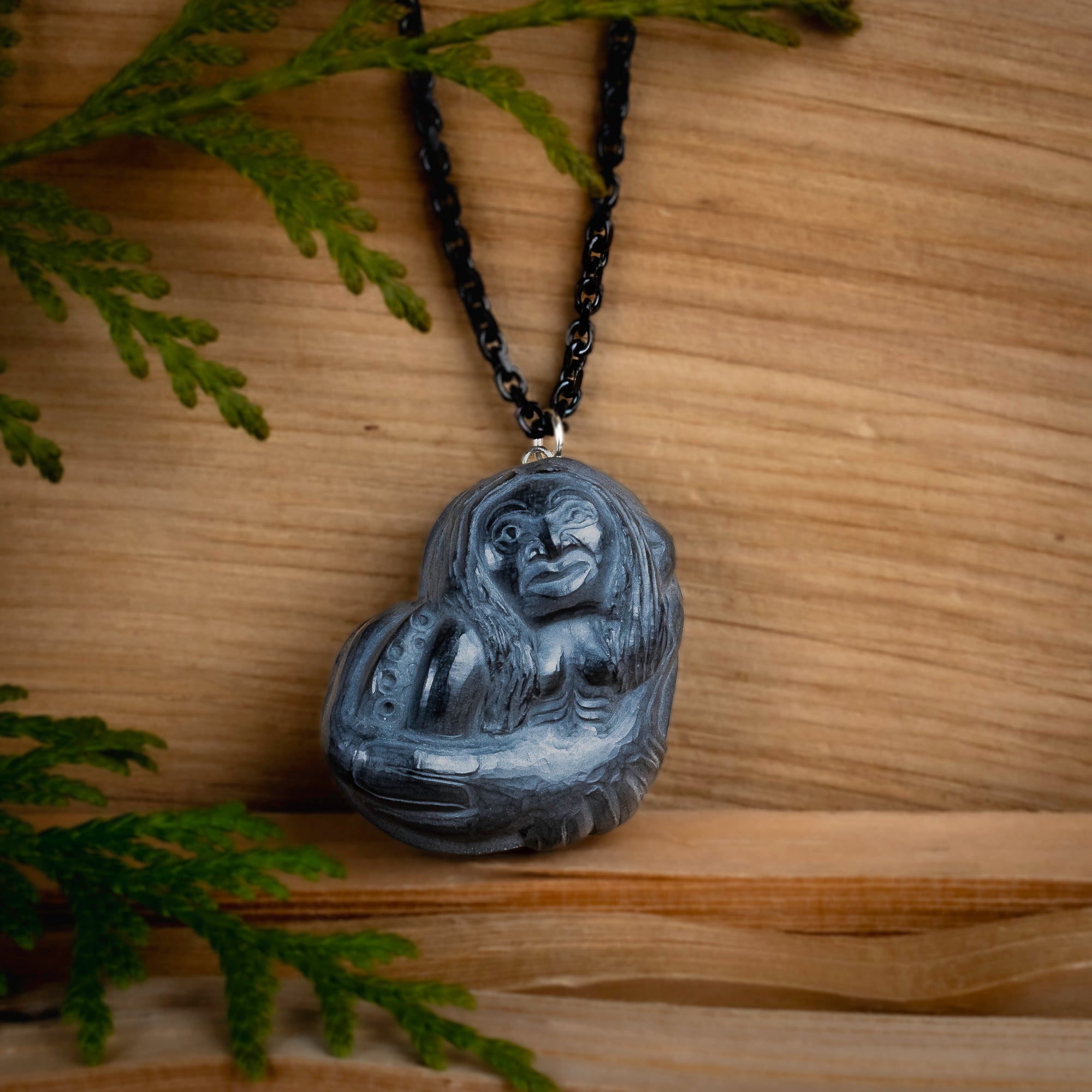 Octopus Women Argillite Pendant made by Canadian artist with a cedar backdrop