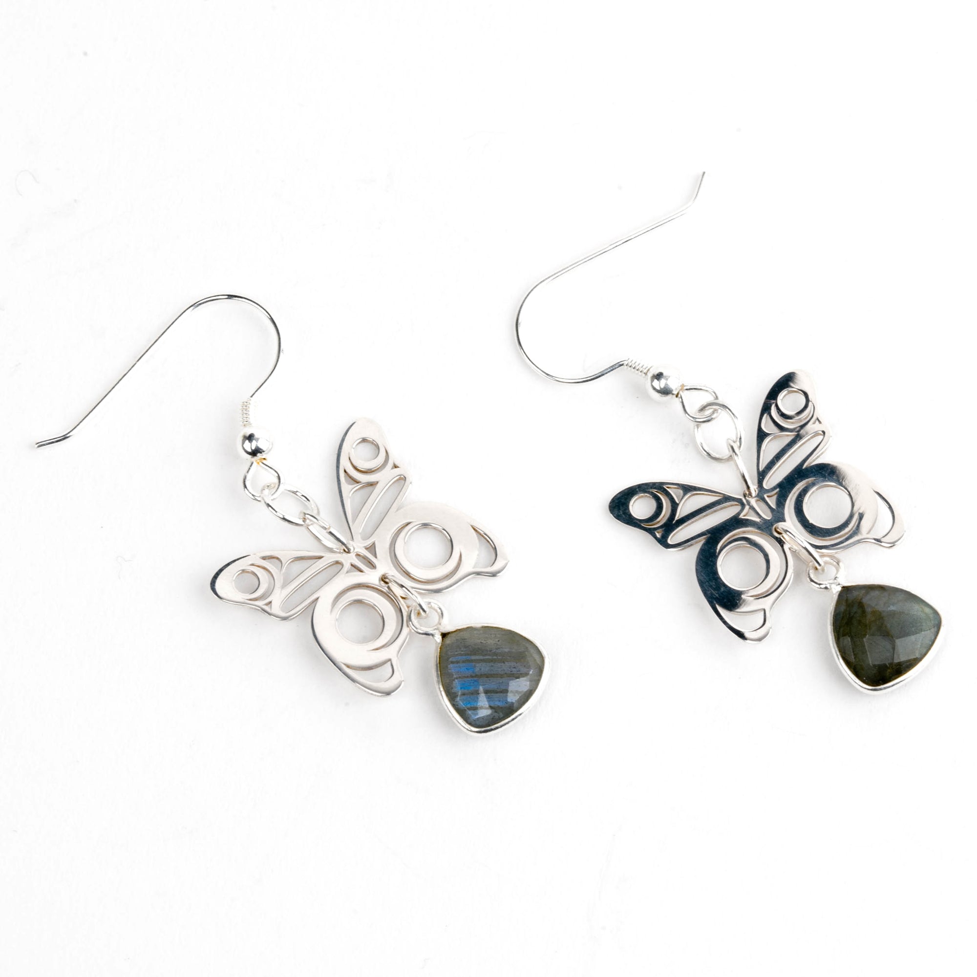 Butterfly-shaped earrings with labradorite stones on a white background