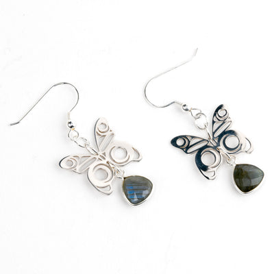 Butterfly-shaped earrings with labradorite stones on a white background
