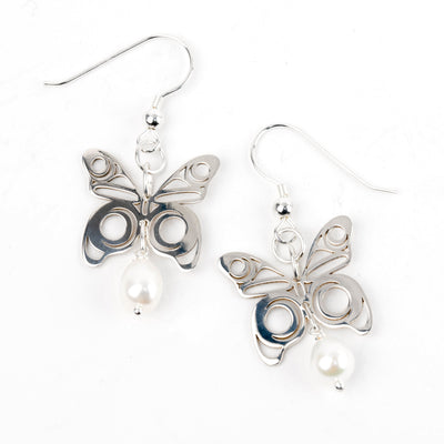 Butterfly-shaped earrings with pearl accents on a white background
