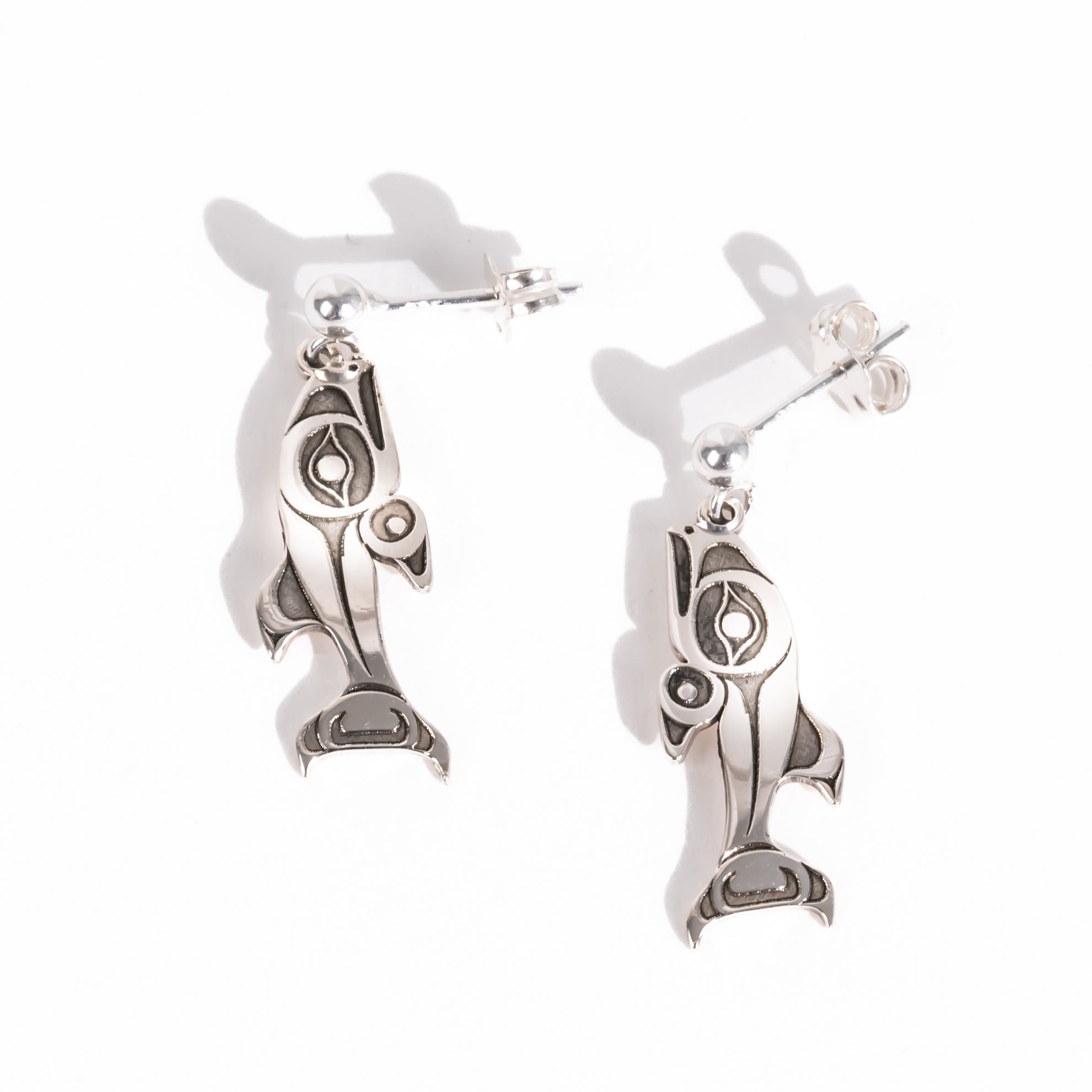 Sterling Silver Salmon dangle stud earrings on a white background by Native artist Morgan Asoyuf