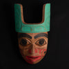 Ornate Cedar Mouse Woman mask with teal top and black and red face done by Haida artist Corey Bulpitt on a black background