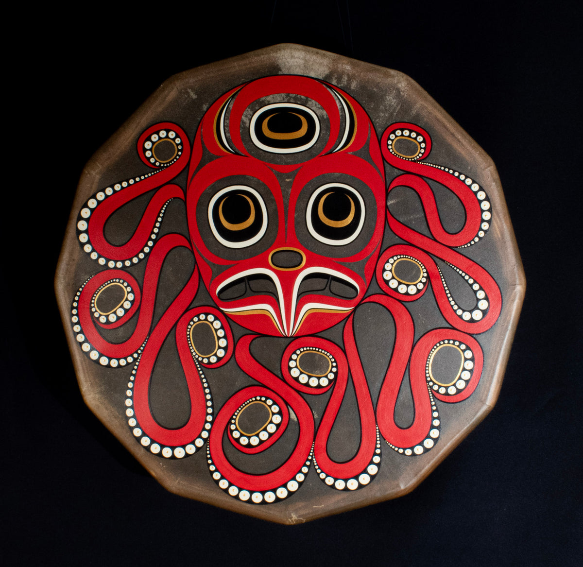 A painting of an octopus design on a deer hide drum