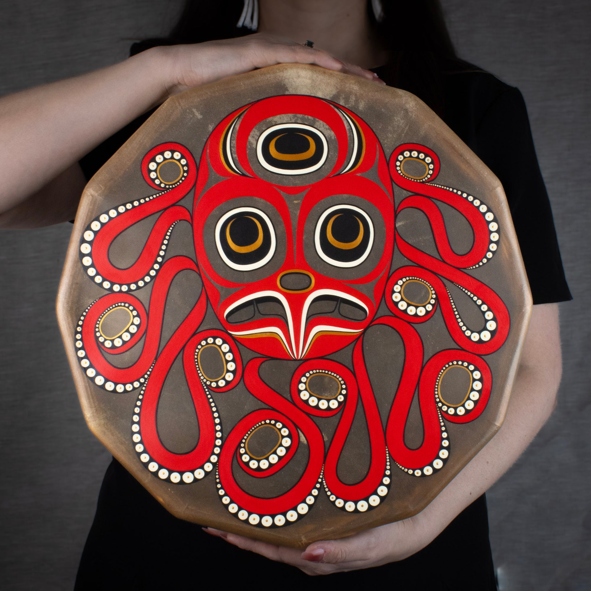 Woman holding a drum with octopus design