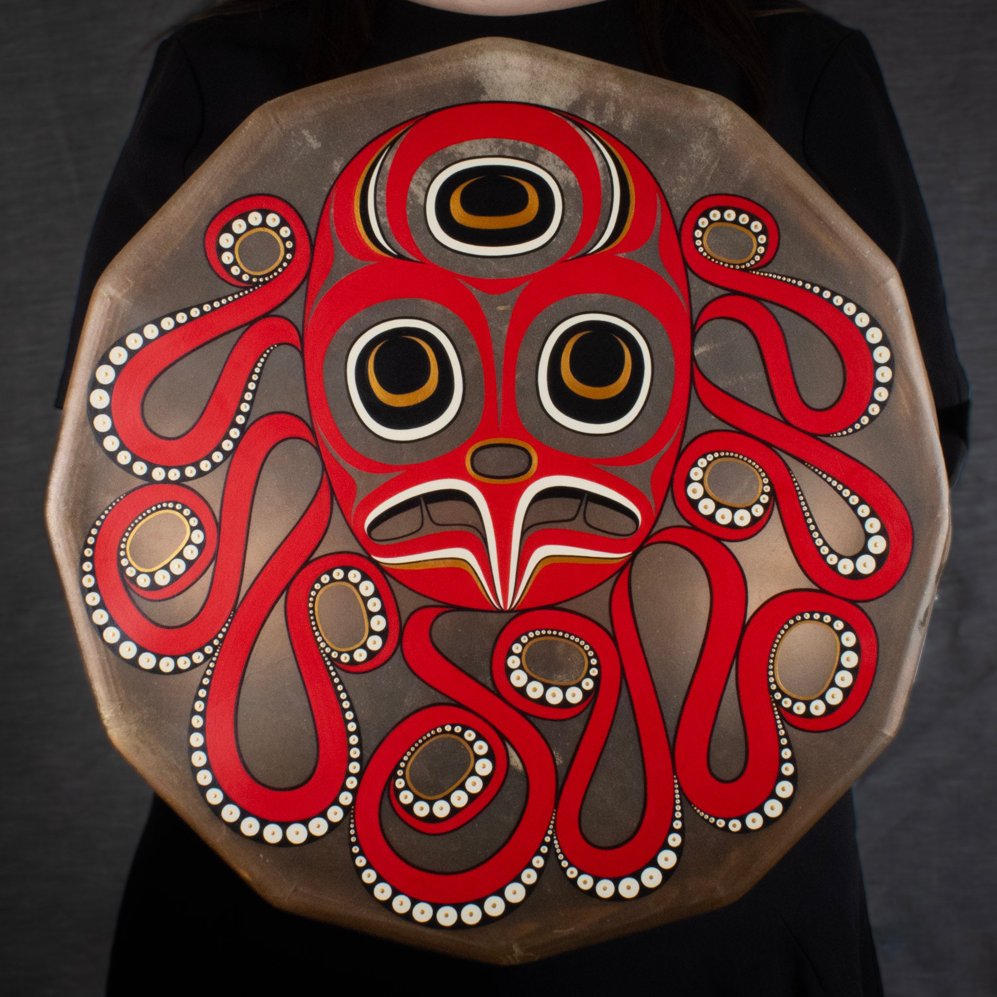 Woman holding a drum with octopus design