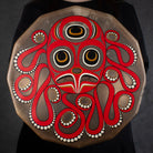 Woman holding a drum with octopus design