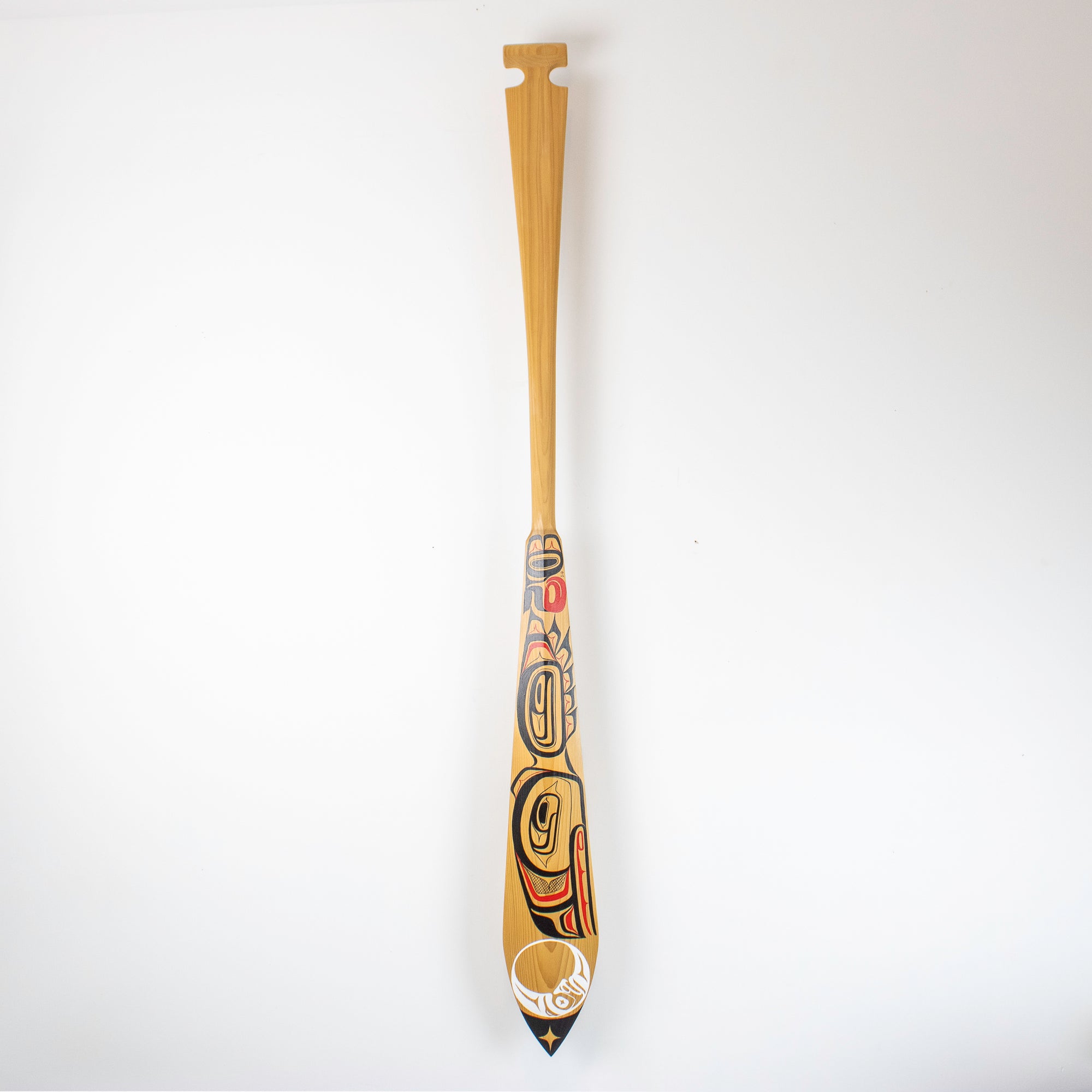 Full angle of painted paddle with northwest coast design