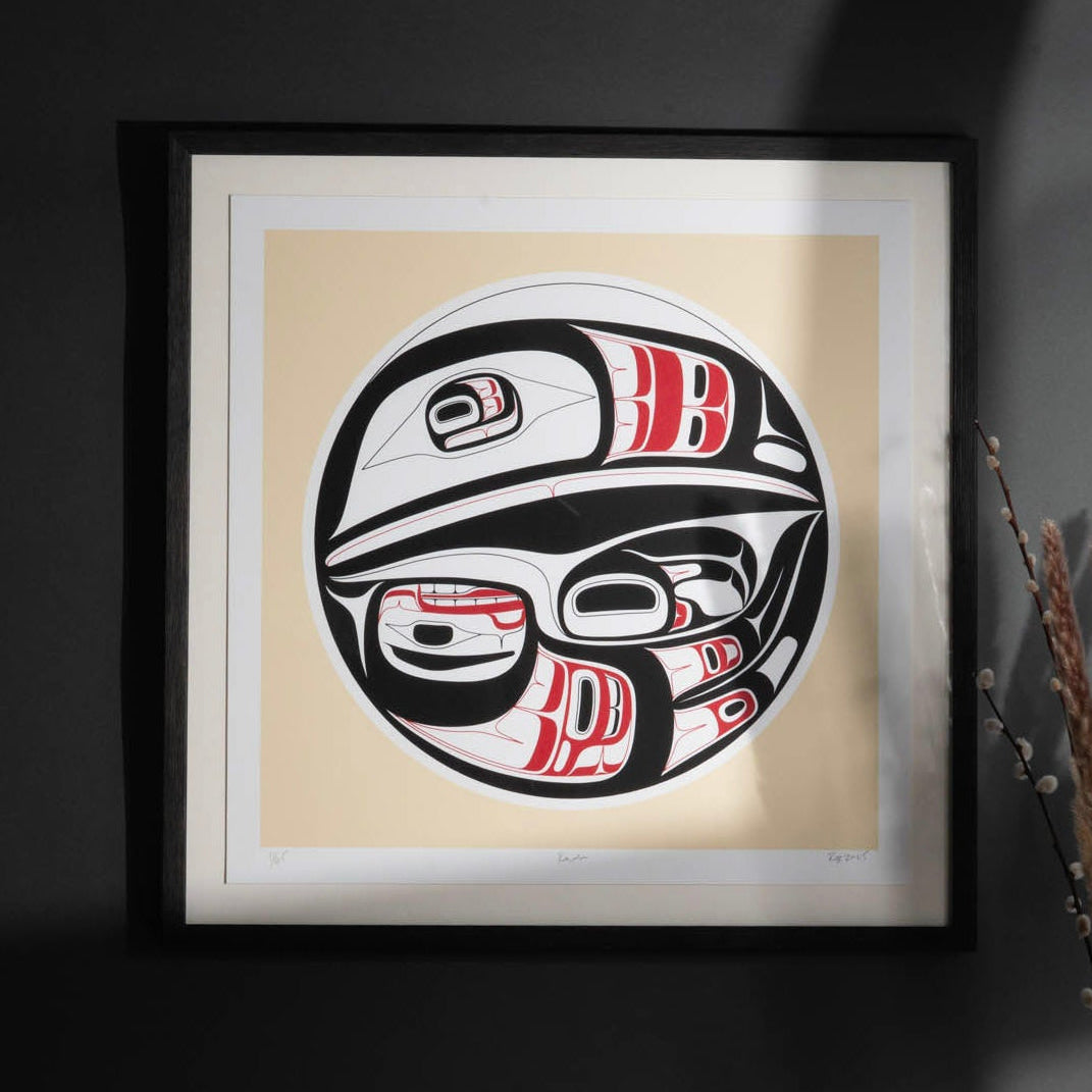 Framed artwork of a Native American Raven with red and white accents on a beige background.