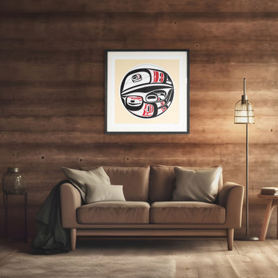 FramedHaida Formline Raven artwork above a brown sofa in a room with wooden walls and a floor lamp.