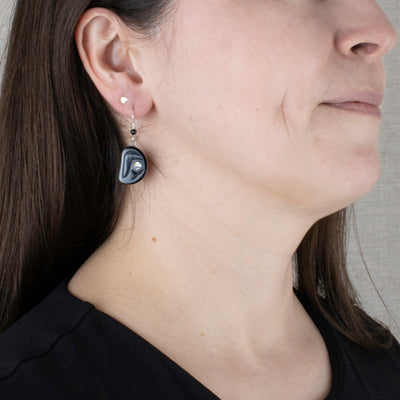 Argillite Salmon Egg earrings with  abalone inlay, and Shepard hooks with small black bead