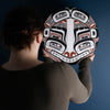 Sea Grizzly panel by Local Haida Gwaii artist Shoshannah Green hand painted on wood. In traditional black red and white. Held by model admiring it