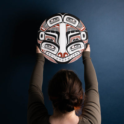 Sea Grizzly panel by Local Haida Gwaii artist Shoshannah Green hand painted on wood. In traditional black red and white held by model placing on the wall