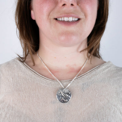 Silver northwest coast hummingbird pendant worn by model